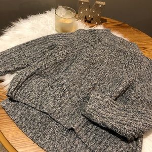 Knitted turtleneck sweater.